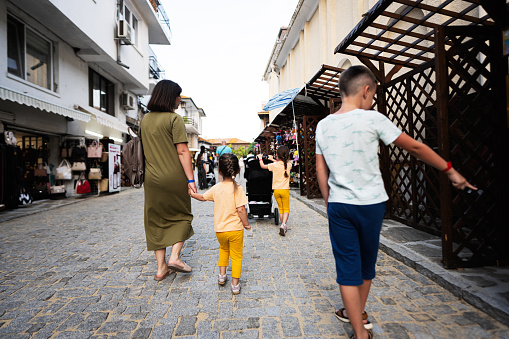Family walking on the street of the old town Nessebar, Bulgaria.