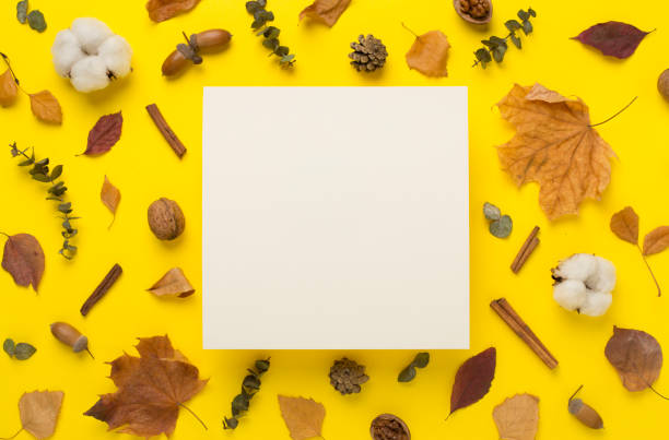 istock Greeting card mockup with autumn leaves on color background, top view 1601622467