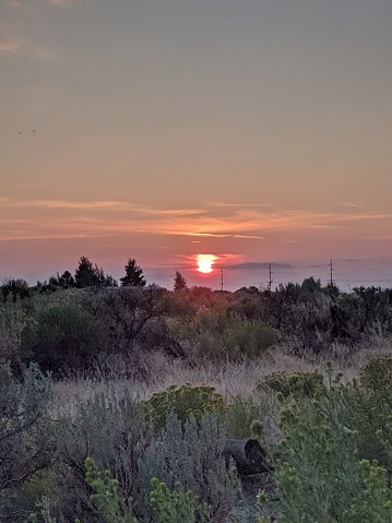 The sunset through the smokey sky at dusk in central Oregon USA
