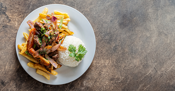 Lomo Saltado (Peruvian Stir-Fried Beef) with french fries, plantain and egg