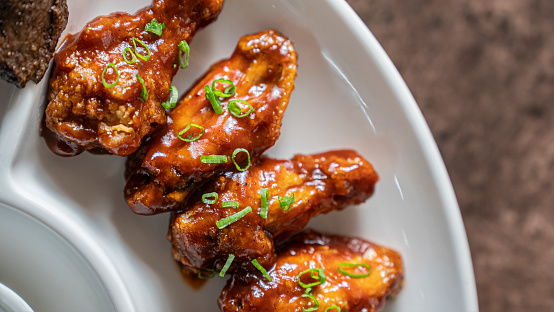 Chicken wings with sweet chili sauce in a plate