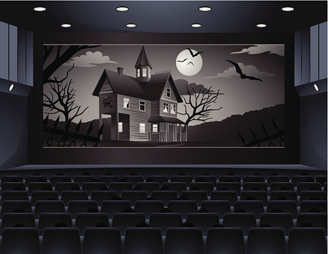 People watching old spooky movie in cinema.