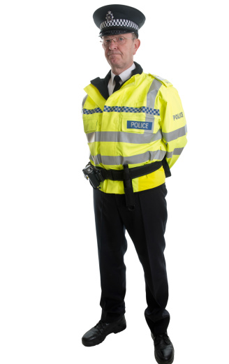 One man only / waist up / front view / looking at camera of 30-39 years old adult handsome people brown hair / short hair / with beard caucasian male / young men police force / security staff in front of white background wearing hat / badge / necktie / uniform / button down shirt / shirt who is serious / confidence / concentration