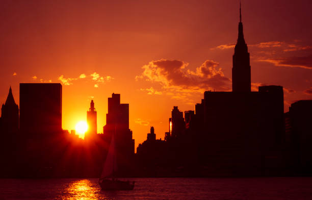 Viewing the iconic One World Trade Center and the New York City skyline while sailing on the waters during sunset.