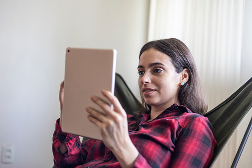 Caucasian woman using tablet in living room at home