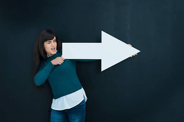 My targets: woman pointing Woman with white arrow pointing to her targets. arrows pointing up stock pictures, royalty-free photos & images