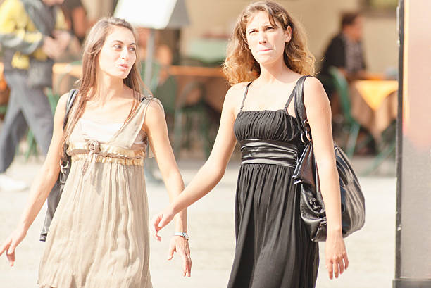 Young woman friends walking on the park.