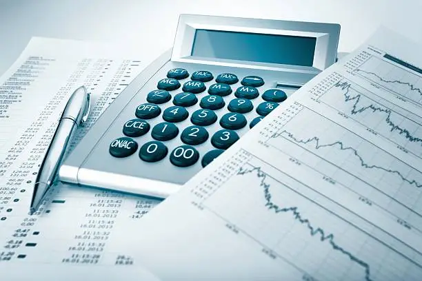 Photo of Calculator and charts and documents