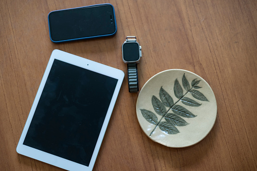 Electronic gadgets on the table such as tablet, mobile phone and smartwatch