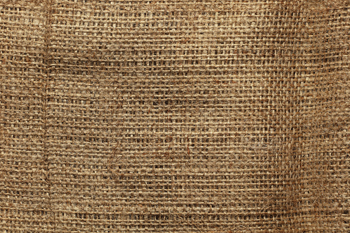 Burlap fabric texture. Light rough vintage background.