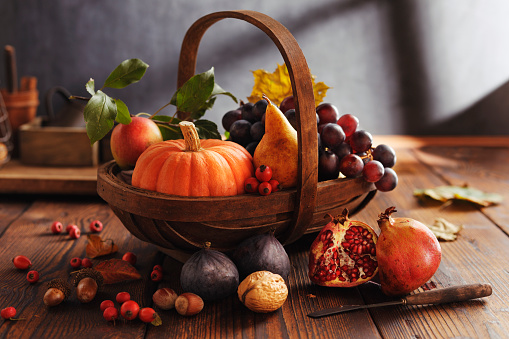 Maple leafs, nectarine, grapes and other gifts of nature. Autumn still life.