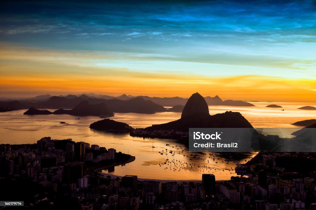 Rio de Janeiro City A new day starts in Rio, the capital of carnival and soccer. View of the city from one of the touristic points of the city, where people from all over the world come to appreciate the beauty of Rio, the Sugar Loaf mountain  and the Guanabara bay. Rio de Janeiro Stock Photo