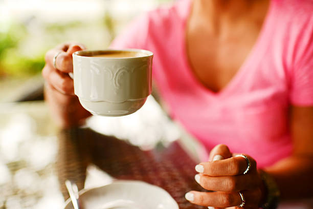 istock Woman drinking coffee in outdoors cafe 160179786
