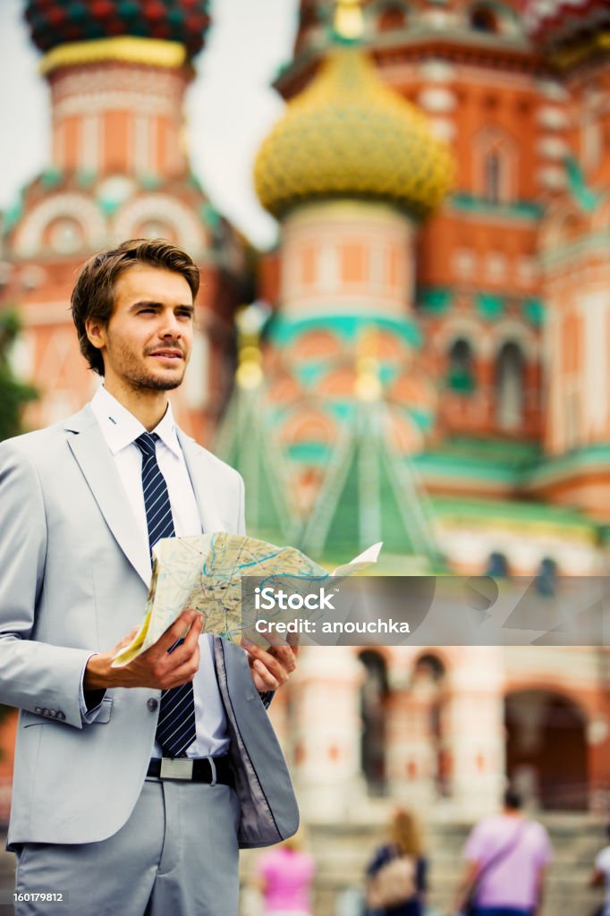 Handsome Young Businessman in Moscow holding street map Businessman Stock Photo