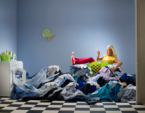 young woman gets overwhelmed with the washing