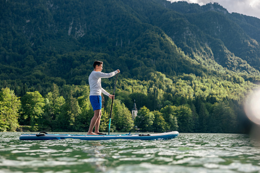 Mature Man Stand Up Paddling On A Lake In Slovenia