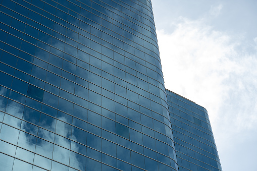 Low angle vision of commercial buildings under blue sky and white clouds