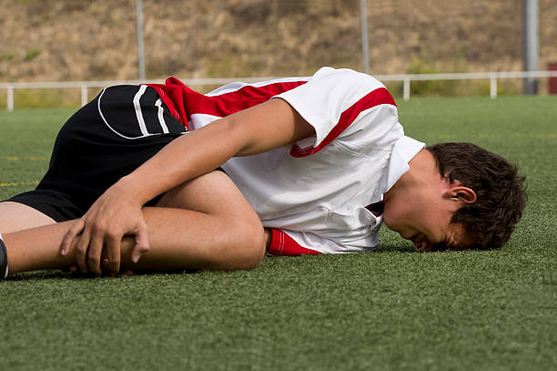 Sports Injury Footballer faking an injury foul stock pictures, royalty-free photos & images