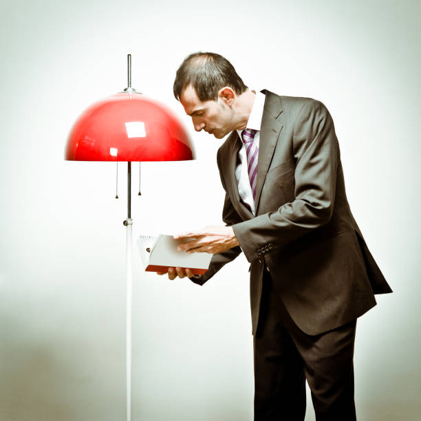 istock Man consulting book near a lamp 160188974