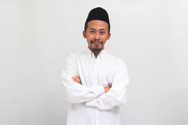 istock Confident young Indonesian man is keeping his arm folded, isolated on white background 1601894584