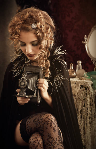 istock woman holding retro camera 160189480