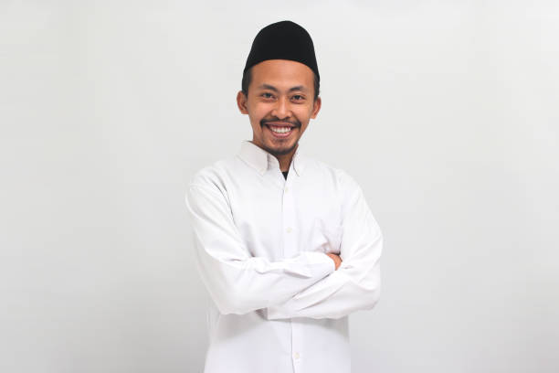 istock Confident young Indonesian man is keeping his arm folded, isolated on white background 1601895637