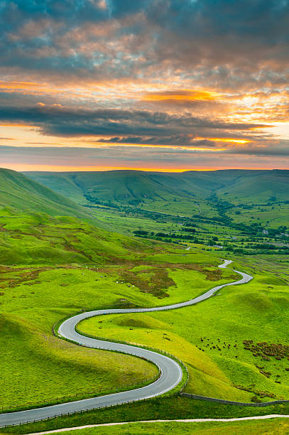 Edale Valley Road, Peak District National Park Looking down on a winding country road that descends into Edale Valley in the Peak District National Park. XL image size. peak district national park photos stock pictures, royalty-free photos & images
