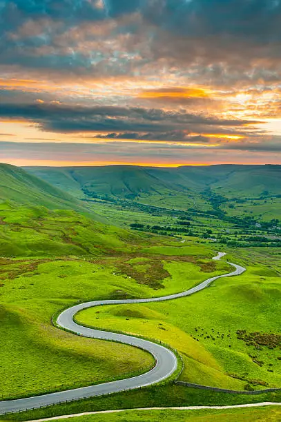 Looking down on a winding country road that descends into Edale Valley in the Peak District National Park. XL image size.