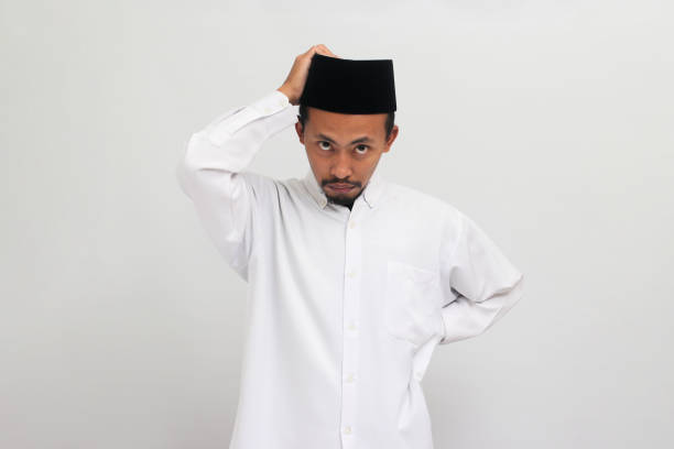 istock Unhappy young Indonesian man grabs his head isolated on a white background 1601898356