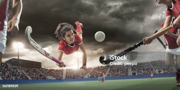 Field Hockey Player Diving To Hit Ball Stock Photo - Download Image Now - Field Hockey, Hockey, Sports Field