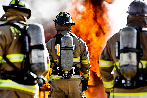 Three Firefighters Three firefighters putting out an house fire. Horizontal shot. firefighter photos stock pictures, royalty-free photos & images