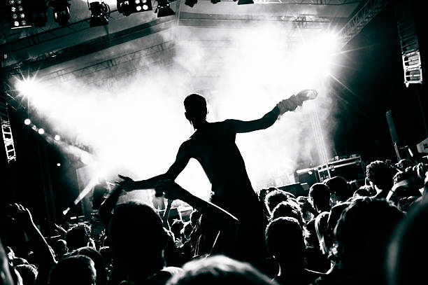 Concert crowd Crowd cheering and watching a band on stage. rock musician photos stock pictures, royalty-free photos & images