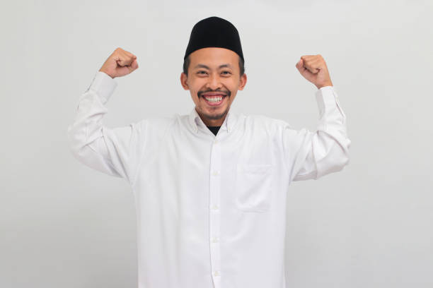 istock Confident young Indonesian man is making a strong gesture, isolated on white background 1601923549