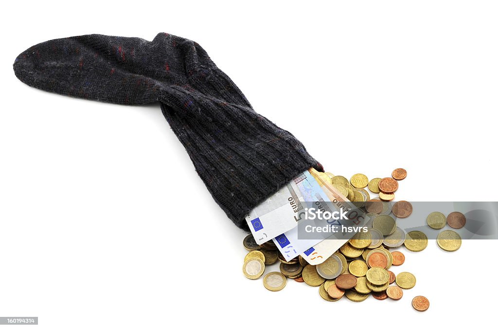 Euro coin and paper currency falling out of money sock Euro coin and Euro paper currency falling out money sock Sock Stock Photo