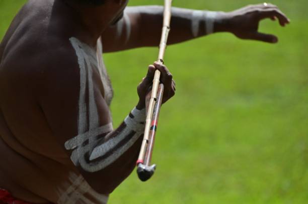 Cape York, Qld - May 23 2023:Australian Aboriginal adult man hunting with a spear.Traditional Aborigines have been regarded as the sole surviving representatives of hunters and gatherers in Oceania