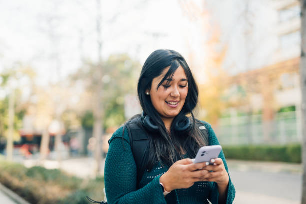 istock Woman using smartphone on the way 1601947805
