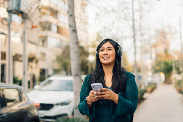 istock Young woman using GPS on smartphone in the city 1601947810