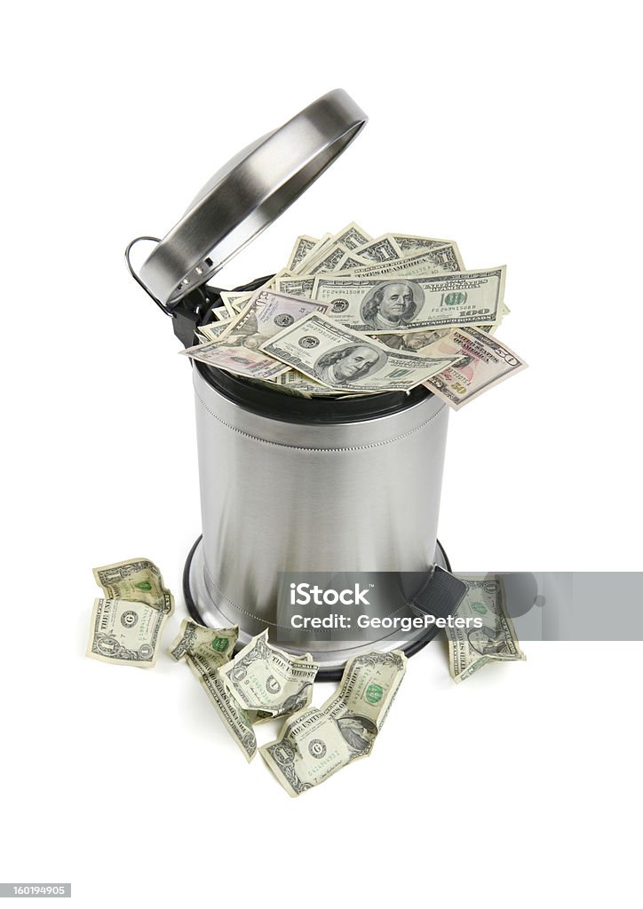 Trash Can and Money with Clipping Path Throwing money away. Worthless money. Inflation. Recession. Wasteful spending. Currency Stock Photo
