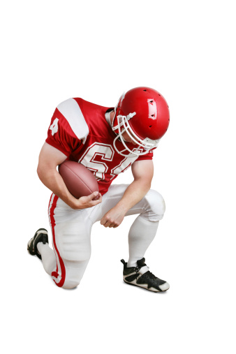 Football player giving thanks. Isolated on white with drop shadow and clipping path.
