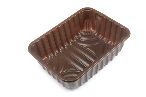 Brown, plastic, packing tray isolated on white.