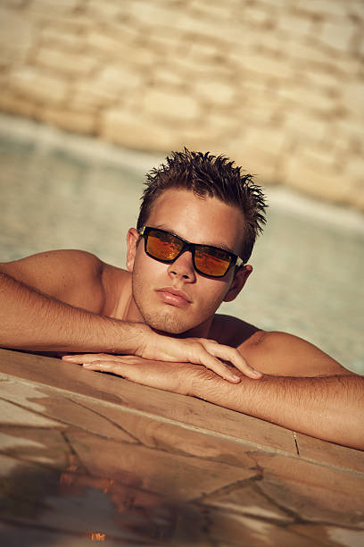 istock Young man relaxing in the swimming pool 160195690