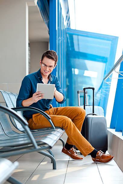 istock Young man with digital tablet at the airport 160195851