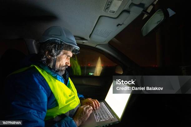 Night Shift At Wind Farm Engineer Works Late In Car Stock Photo - Download Image Now