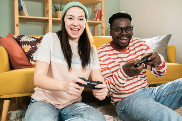 istock Happy couple gaming at home 1601974536