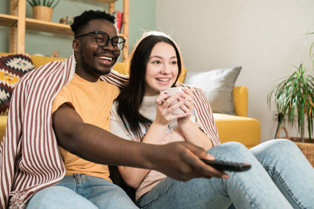 istock Happy couple watching TV at home 1601974547
