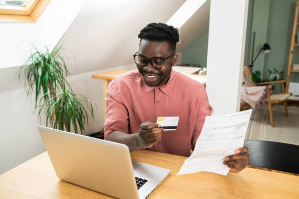 istock Young man making an online payment from home 1601975073