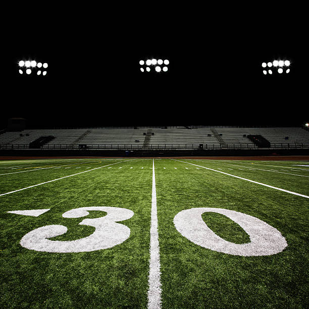 Football Field at Night  football field night american culture empty stock pictures, royalty-free photos & images