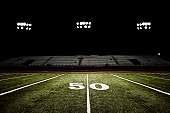 Fifty-yard line of football field at night