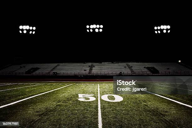 Fiftyyard Line Of Football Field At Night Stock Photo - Download Image Now - American Football Field, American Football - Sport, Stadium