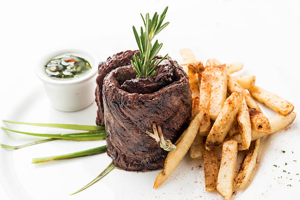Grilled Skirt Steak with fries and chimichurri sauce on white background